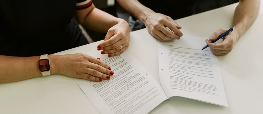 hands working on papers